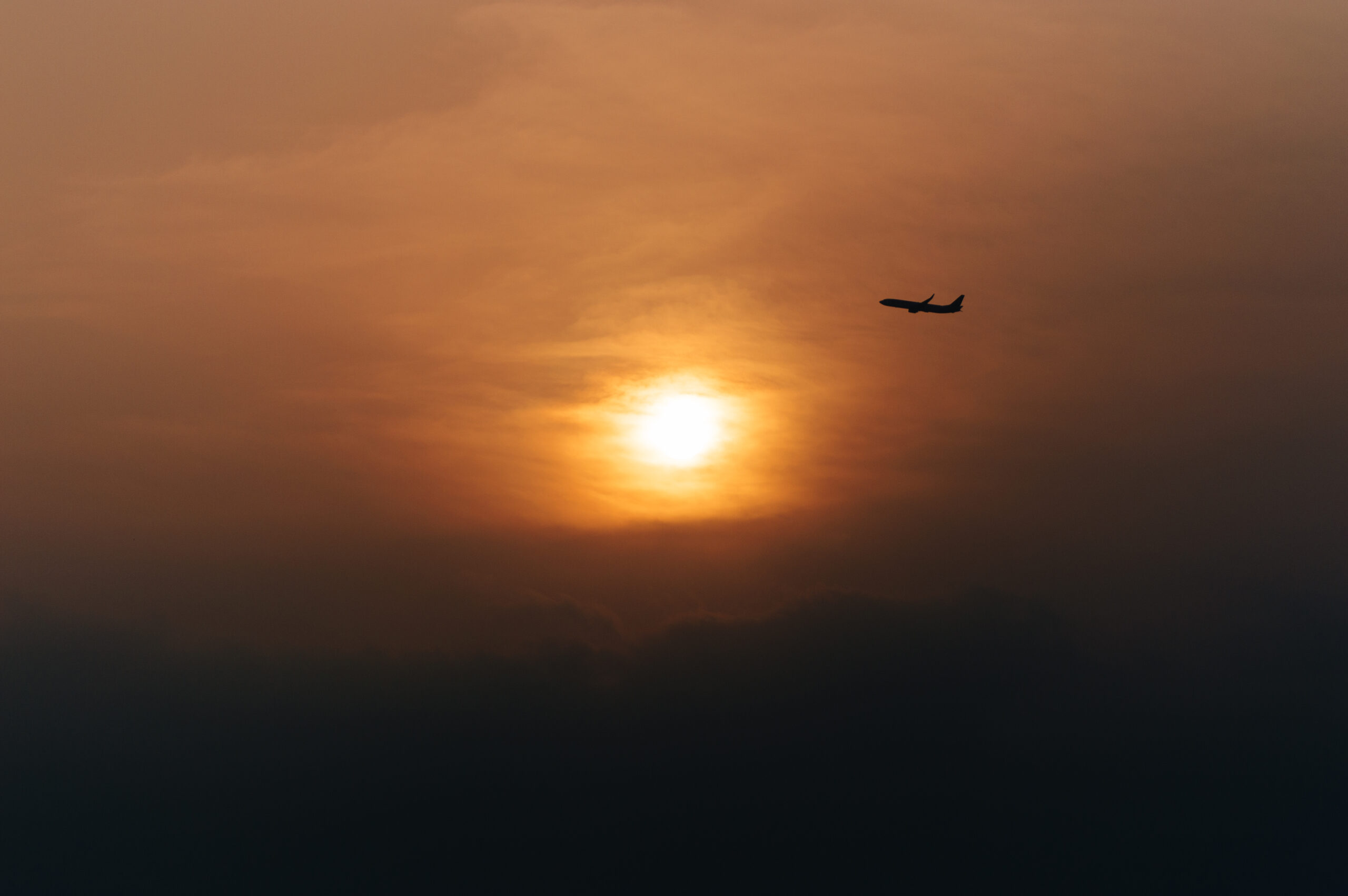 美麗的夕陽,飛機剪影掠過畫面
